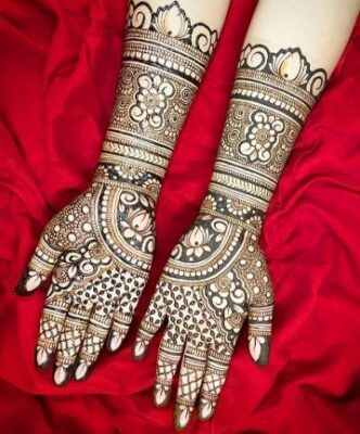 A peacock Full Hand Mehndi Design symbolizes beauty and luck