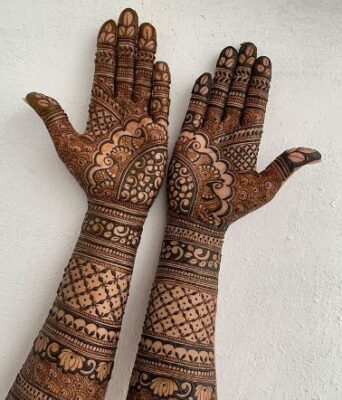A stylish bridal Full Hand Mehndi Design completes the bridal look