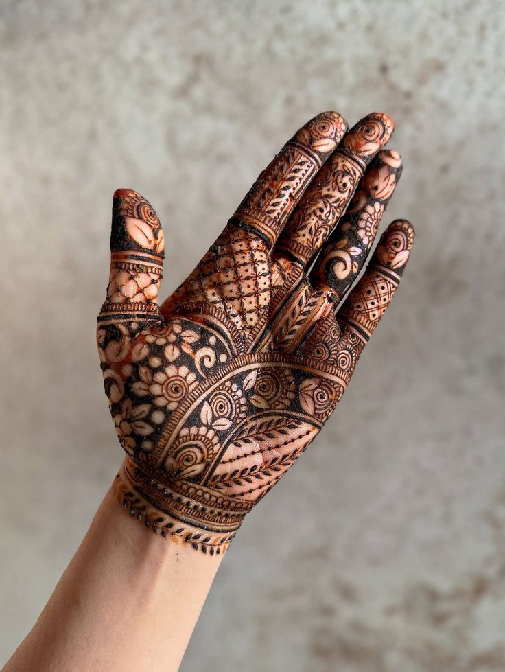 A floral finger mehndi design adds soft beauty