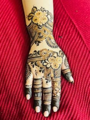 Stylish Back Hand Mehndi Design matches well with ethnic jewelry