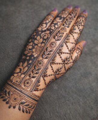 Stylish Back Hand Mehndi Design uses floral and leafy patterns
